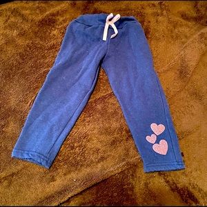 Blue pants with pink glitter hearts and bow